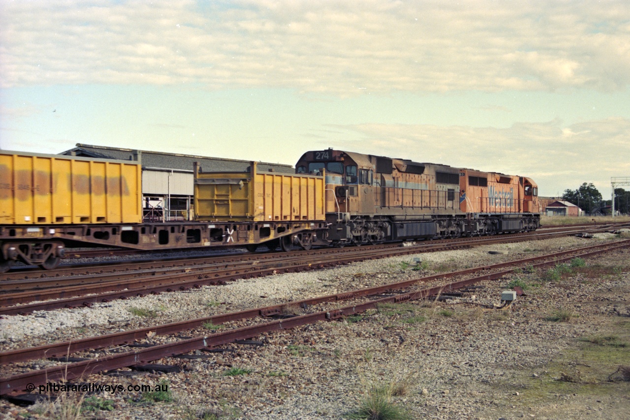 186-02
Midland, Westrail standard gauge up Kalgoorlie loaded acid train 428 behind a pair of L class locomotives L 263 Clyde Engineering EMD model GT26C serial 68-553 and L 274 built by Comeng Qld serial 73-779 in 1973 for Western Mining Corporation, with nickel containers as part of the loading, the narrow gauge track to the Flashbutt yard in the foreground and Midland Workshops behind train.
Keywords: L-class;L274;Comeng-Qld;EMD;GT26C;73-779;