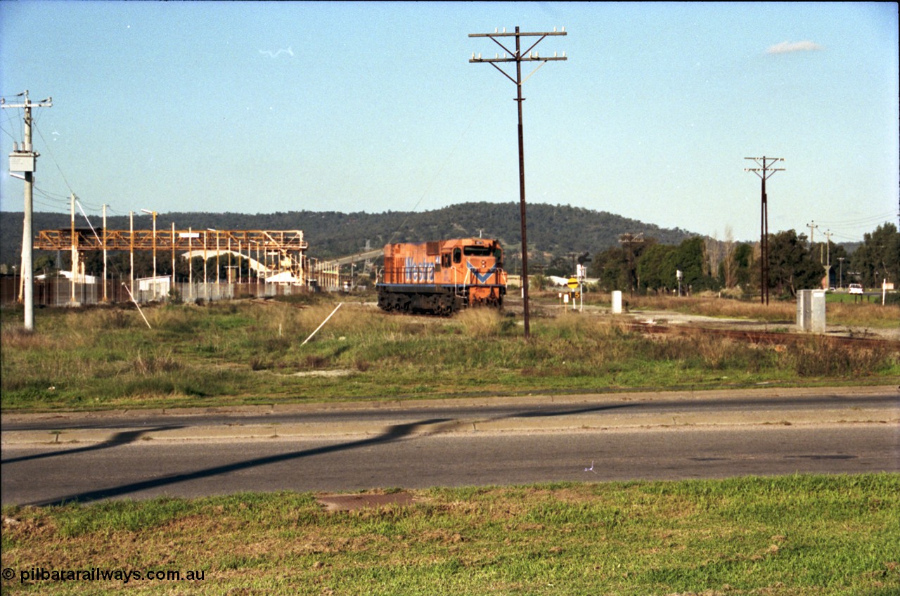 186-23
Bellevue, Westrail standard gauge light engine movement, train 168 stands in the flashbutt sidings prior to departure back to Forrestfield. NB class locomotive NB 1873 a Comeng built ALCo model CE618 serial WA-79 / C6099-3. This unit was originally a WAGR N class on narrow gauge, then reclassed to NA when fitted with air brakes in 1983, and then fitted with ex Mt Newman Mining ALCo M636 bogies in 1994 and classed NB.
Keywords: NB-class;NB1873;Comeng-WA;ALCo;CE618;WA-79/C6099-3;N-class;NA-class;rebuild;