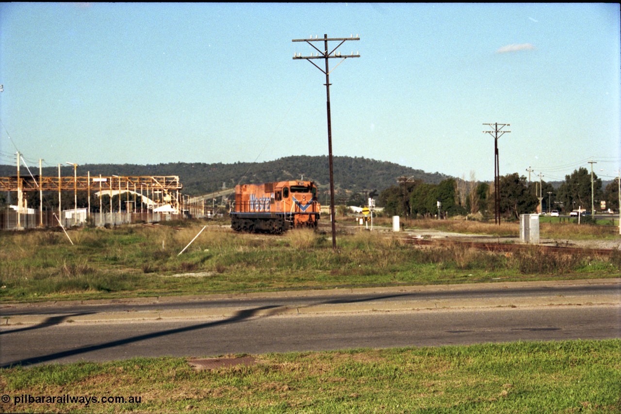 186-24
Bellevue, Westrail standard gauge light engine movement, train 168 stands in the flashbutt sidings prior to departure back to Forrestfield. NB class locomotive NB 1873 a Comeng built ALCo model CE618 serial WA-79 / C6099-3. This unit was originally a WAGR N class on narrow gauge, then reclassed to NA when fitted with air brakes in 1983, and then fitted with ex Mt Newman Mining ALCo M636 bogies in 1994 and classed NB.
Keywords: NB-class;NB1873;Comeng-WA;ALCo;CE618;WA-79/C6099-3;N-class;NA-class;rebuild;
