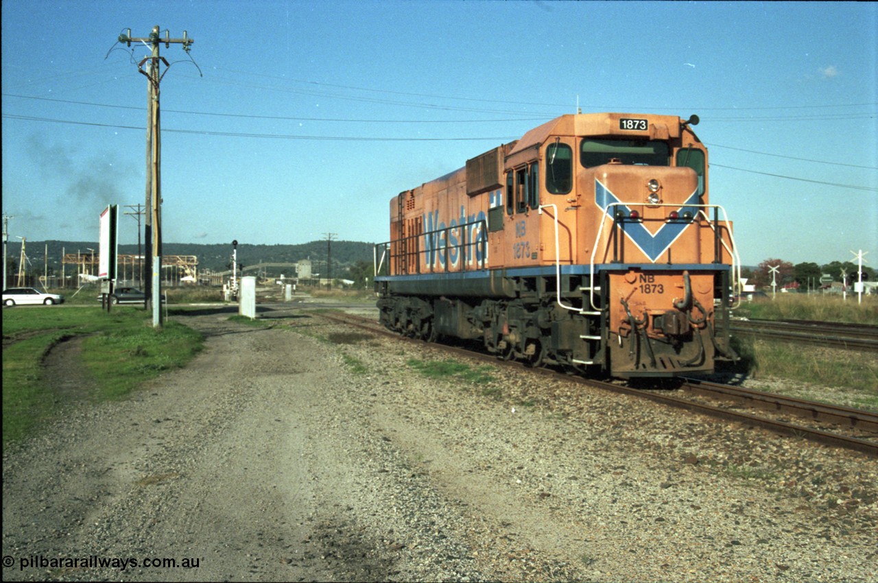 186-26
Bellevue, Westrail standard gauge light engine movement, train 168 departs the flashbutt sidings crossing Lloyd Street bound for Forrestfield. NB class locomotive NB 1873 a Comeng built ALCo model CE618 serial WA-79 / C6099-3. This unit was originally a WAGR N class on narrow gauge, then reclassed to NA when fitted with air brakes in 1983, and then fitted with ex Mt Newman Mining ALCo M636 bogies in 1994 and classed NB.
Keywords: NB-class;NB1873;Comeng-WA;ALCo;CE618;WA-79/C6099-3;N-class;NA-class;rebuild;