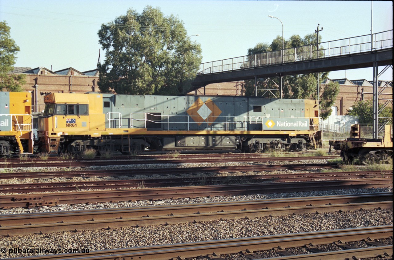 186-29
Midland, standard gauge yard, under the Midland Workshops footbridge, the first completed and built in Bassendean National Rail NR class NR 61 Goninan GE model Cv40-9i serial 7250-11/96-263 trails new sisters NR 101 and NR 102 as they perform their shunt movement.
Keywords: NR-class;NR61;Goninan;GE;Cv40-9i;7250-11/96-263;