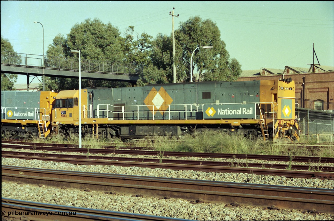 186-34
Midland, standard gauge yard, under the Midland Workshops footbridge, the first completed and built in Bassendean, National Rail NR class NR 61 Goninan GE model Cv40-9i serial 7250-11/96-263 trails new sisters NR 101 and NR 102 as they perform their shunt movement back out towards the mainline.
Keywords: NR-class;NR61;Goninan;GE;Cv40-9i;7250-11/96-263;