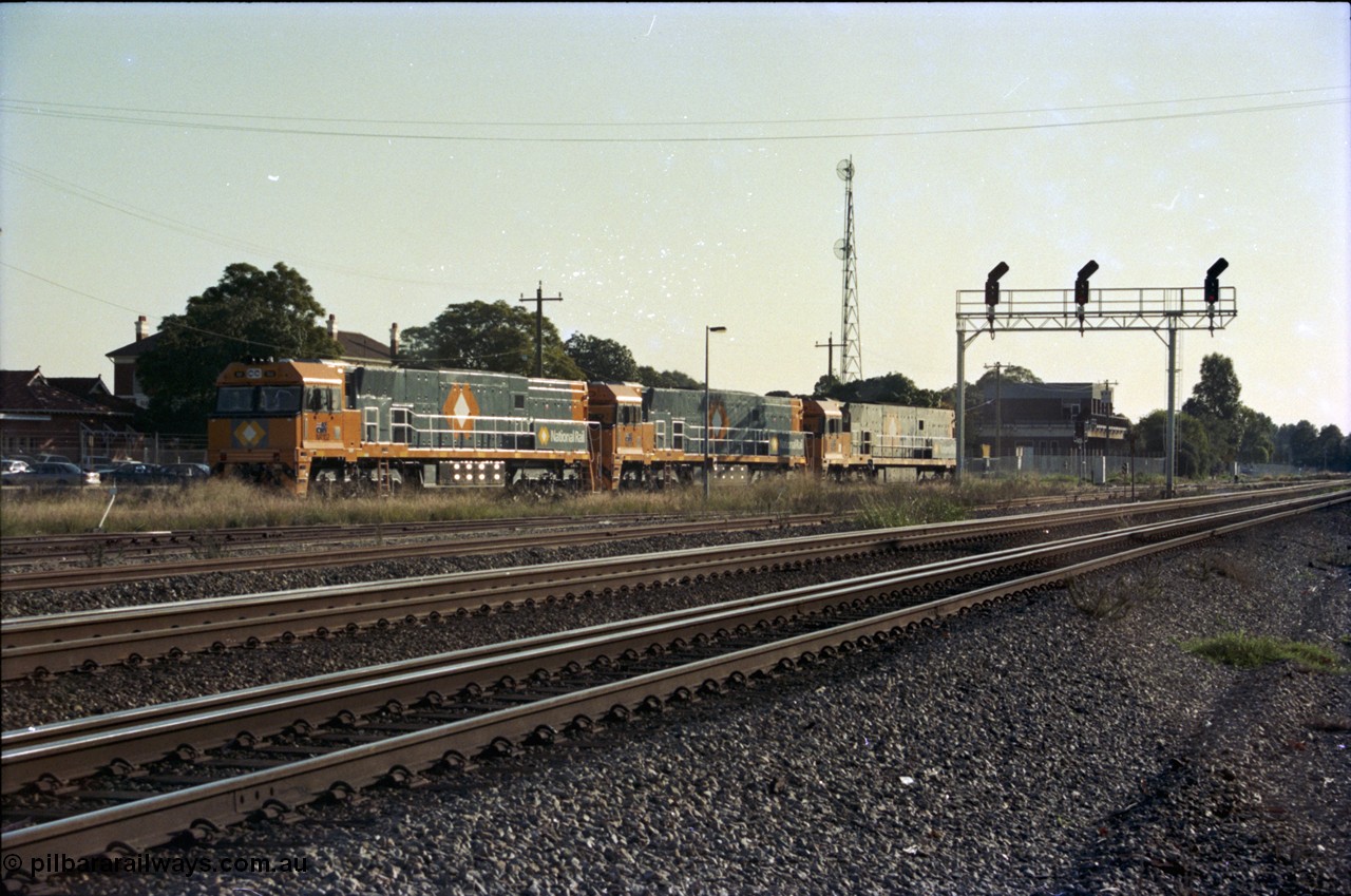186-37
Midland, standard gauge yard, brand new Perth built National Rail NR class units NR 102 Goninan GE model Cv40-9i serial 7250-07/97-302 and NR 101 serial 7250-07/97-303 shunt out of the yard with the first built sister NR 61 serial 7250-11/96-263, the building in the background is MidSig, the train control building, the yard and signal gantry are now gone.
Keywords: NR-class;NR102;Goninan;GE;Cv40-9i;7250-07/97-302;
