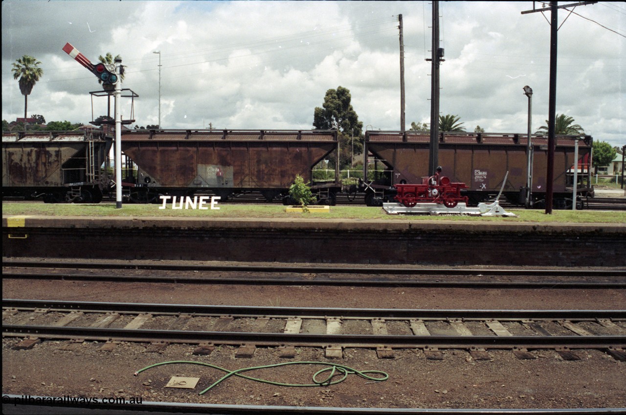 188-22
Junee station on the NSW Main South line, 485 km from Sydney, opened in July 1878, view across to the Up Platform from the Down Platform with NGMA grain waggons in No 2 Up Siding.
