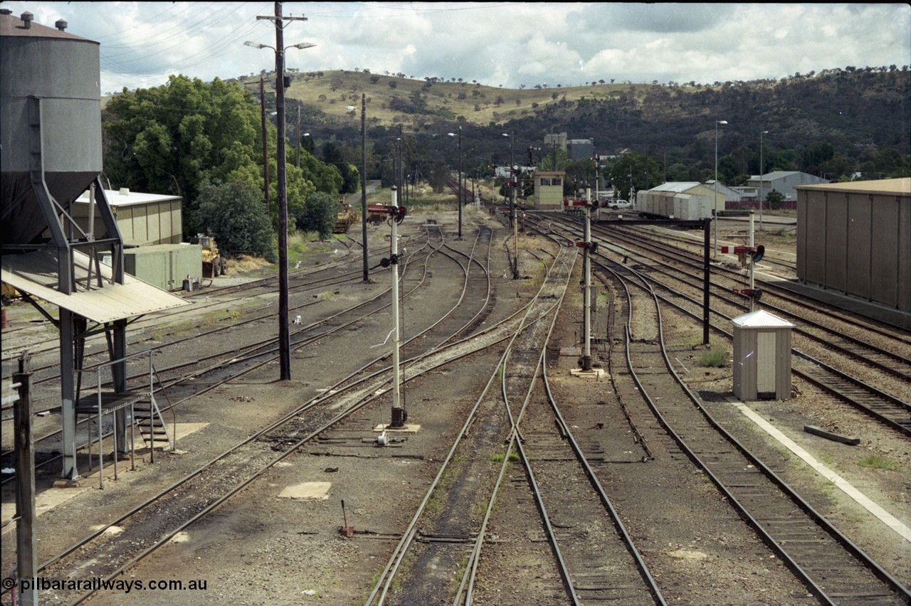 190-02
Cootamundra, NSW Main South, looking south from the pedestrian footbridge, loco depot and sanding tower on the left, South signal box in the distance with a rake of NTBX vans.
