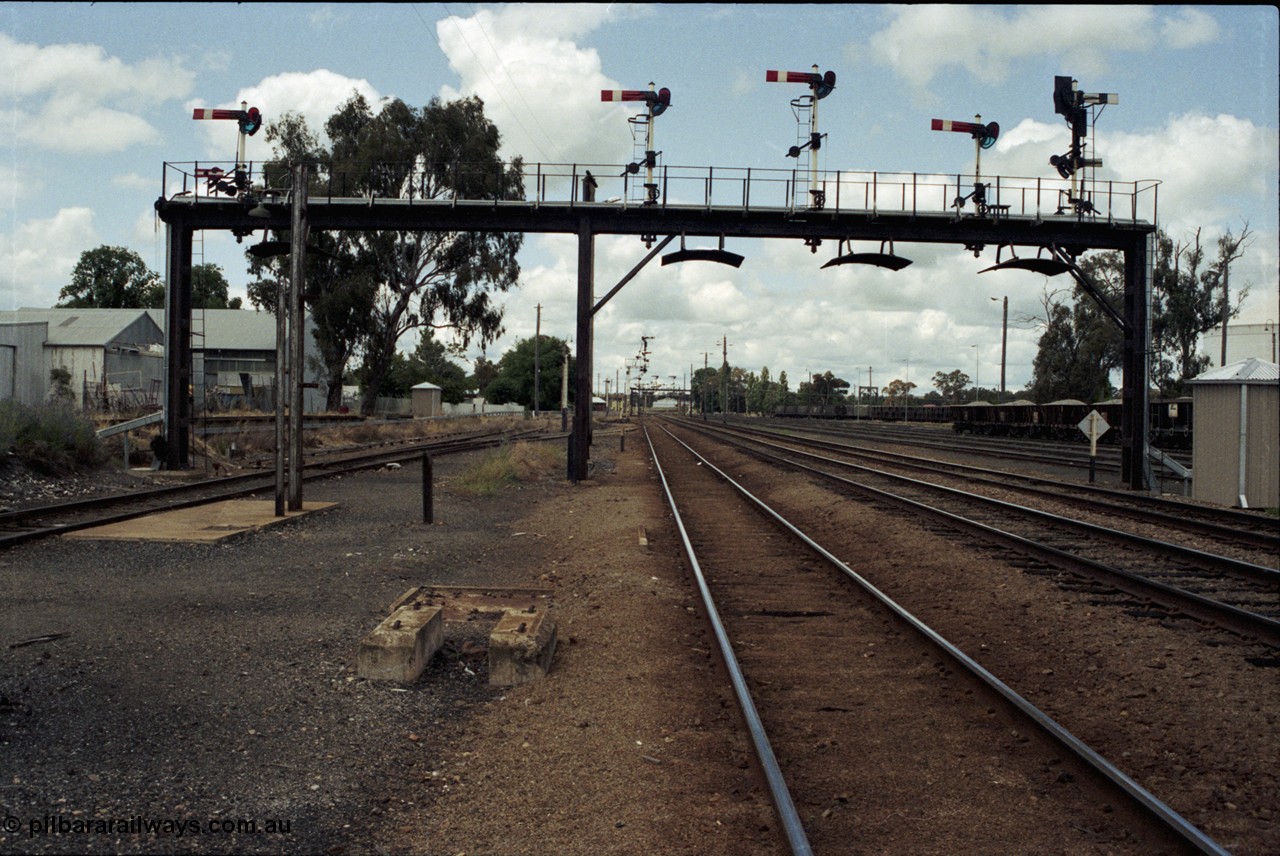 190-05
Cootamundra, NSW Main South, looking north, signal gantry with standpipe foundation in front, platform behind, dock road on the left.
