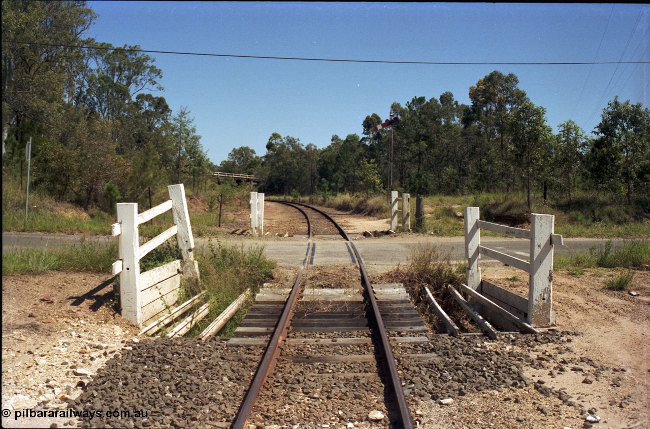 193-14
Moodlu, old grade crossing, looking west in Down direction across what is now Devantier Rd grade crossing, signal is for the Moodlu Quarry junction which is just around the curve. [url=https://goo.gl/maps/DarAzunp67r]GeoData[/url].
