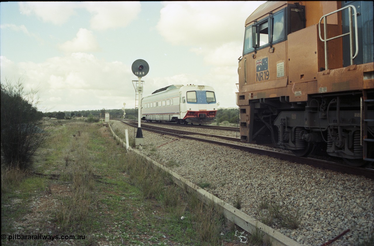199-15
Meckering, Perth bound single Prospector car races along on the mainline as it crosses NR 19 on 7PM5 freighter.
Keywords: NR-class;NR19;Goninan;GE;CV40-9i;7250-03/97-221;