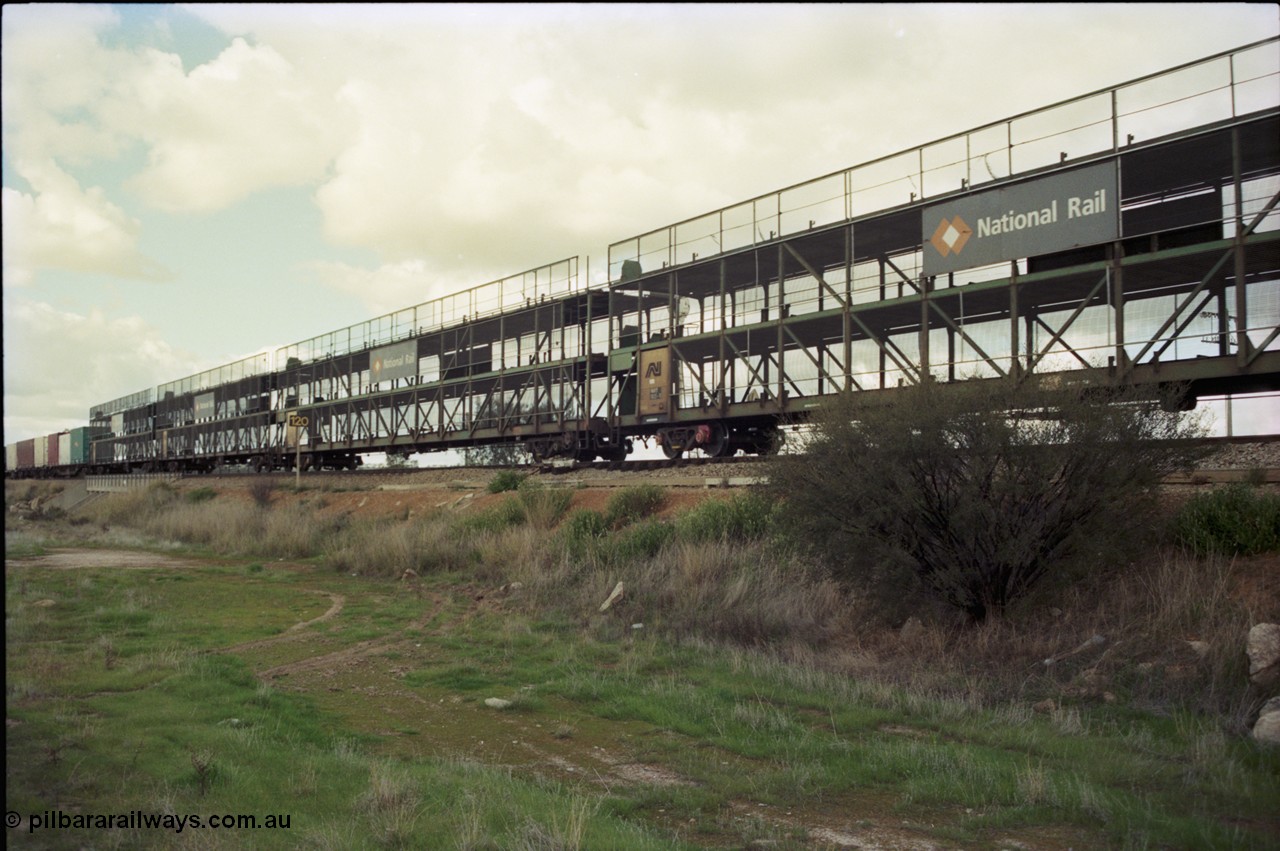 199-21
Meckering, east bound freighter 7PM5 with former Australian National RMDY type triple deck car carriers now branded for National Rail. RMDY type built by Comeng Victoria for Commonwealth Railways in 1976 as GN type, a batch of 30 with the final 15 coded GNX, third deck added to 14 of the first 15 in 1987 and recoded to AMDF, then AMDY to RMDY in 1994.
Keywords: RMDY-type;Comeng-Vic;GN-type;