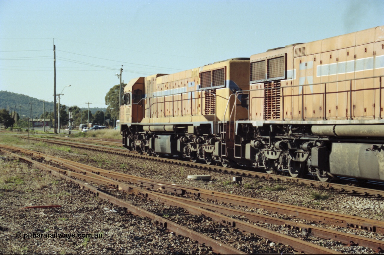 200-23
Midland, Westrail's Clyde Engineering built EMD model G26C as the DA class, DA 1573 serial 72-760 and DA 1574 serial 72-761 lead an empty grain train to Avon near the Lloyd Street grade crossing, 0925 hrs 24th June 1997.
Keywords: DA-class;DA1573;Clyde-Engineering-Granville-NSW;EMD;G26C;72-760;