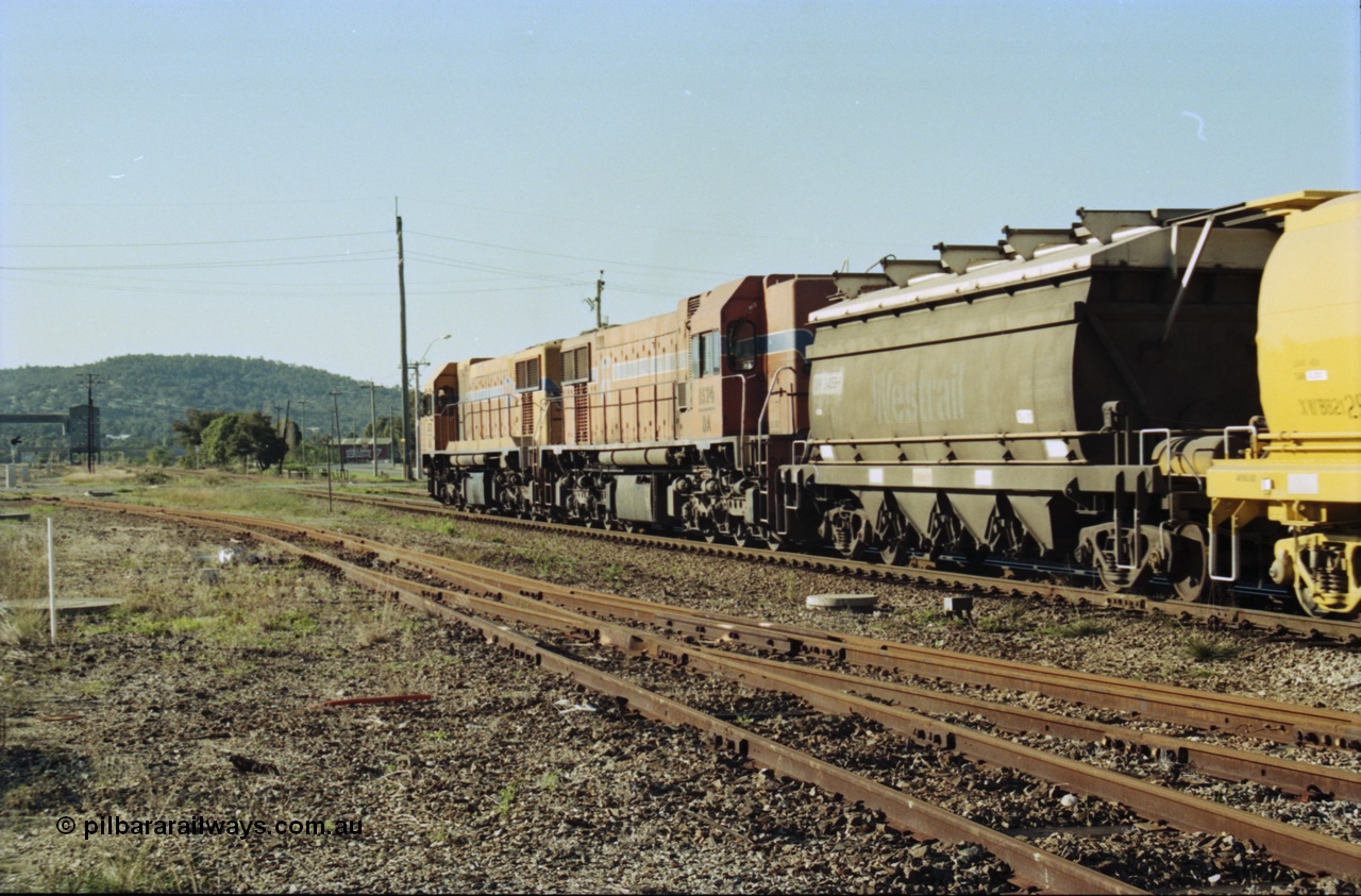 200-24
Midland, Westrail's Clyde Engineering built EMD model G26C as the DA class, DA 1573 serial 72-760 and DA 1574 serial 72-761 lead an empty grain train to Avon near the Lloyd Street grade crossing, lead waggon is an XNW type with the second being an XWBB type 2129, 0925 hrs 24th June 1997.
Keywords: DA-class;DA1573;Clyde-Engineering-Granville-NSW;EMD;G26C;72-760;