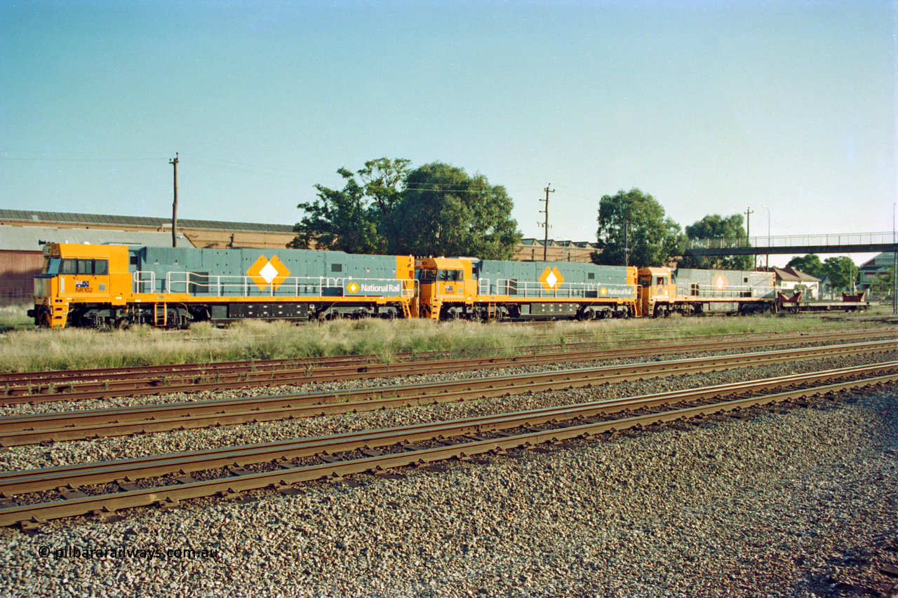 201-00
Midland, two brand Goninan WA built GE Cv40-9i model NR class units NR 102 serial 7250-07/97-302 and NR 101 serial 7250-07/97-303 lead the original Perth built NR 61 serial 7250-11/96-263 as the shunt around the yard.
Keywords: NR-class;NR102;Goninan;GE;CV40-9i;7250-07/97-302;