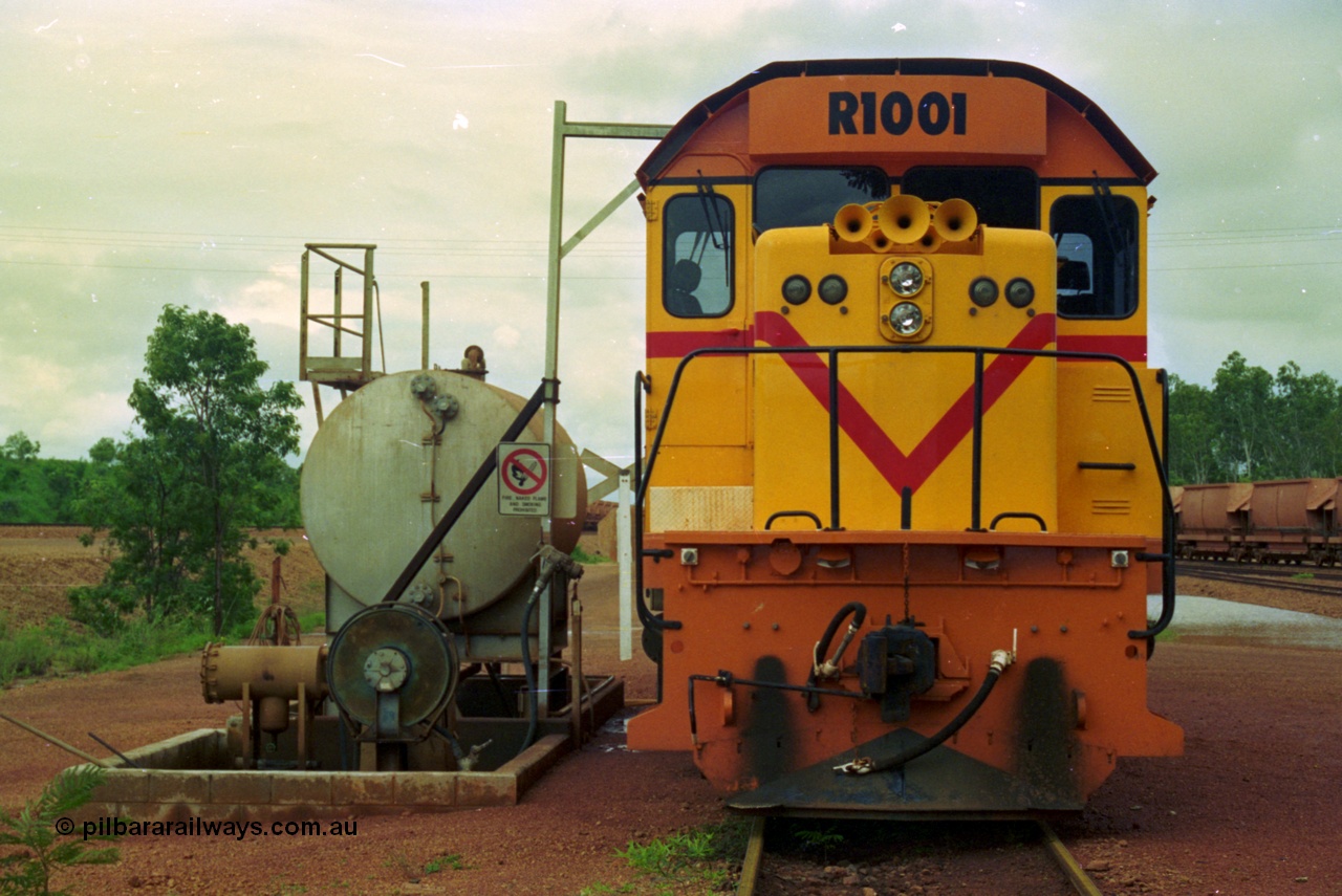 210-07
Weipa, Lorim Point railway workshops, front view of Comalco R 1001 loco Clyde Engineering EMD model GT26C serial 72-752 while is sits at the fuel point, items of note are the second 'tropical roof' and the five chime horn cut into the nose. Also as the Weipa locomotives don't work in MU there is only the train brake hose and the main res hose for charging the belly dump discharge doors.
Keywords: R1001;Clyde-Engineering;EMD;GT26C;72-752;1.001;Comalco;