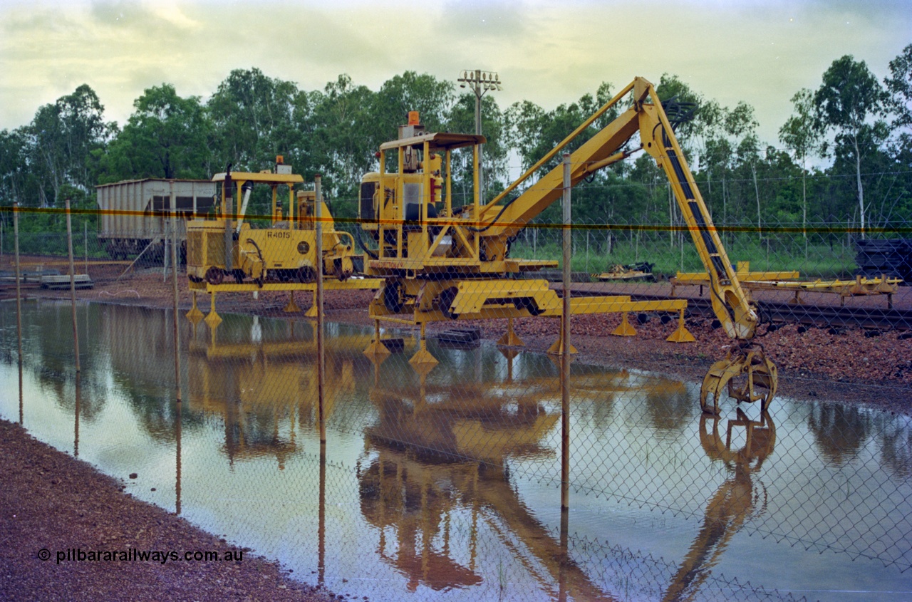 210-17
Weipa, Lorim Point track maintenance compound, sleeper handler crane and a sleeper scarifier - inserter beside it numbered R 4015, ballast waggon R 4003 in the background.
Keywords: Comalco;