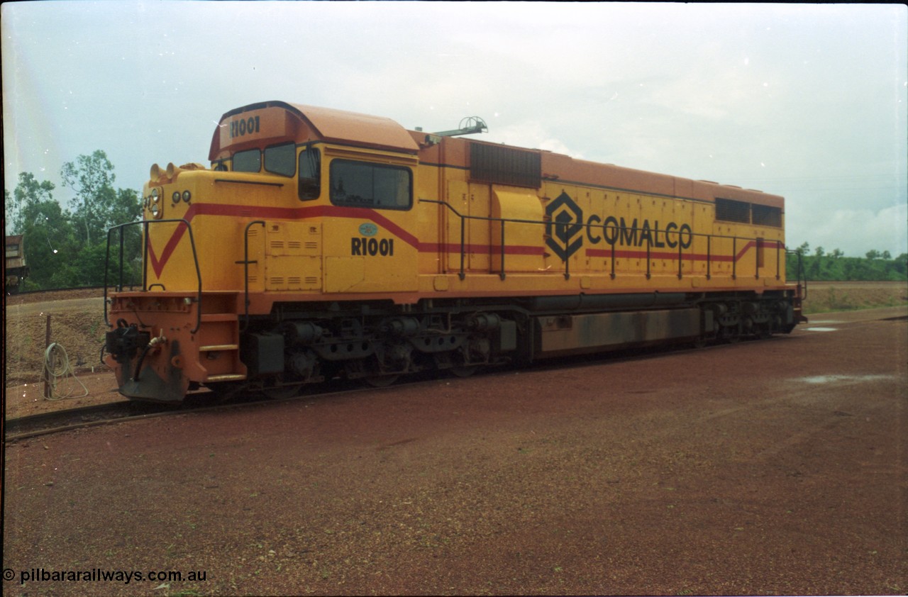 211-26
Weipa, Lorim Point railway workshops, 3/4 RHS or observer's side view of Comalco R 1001 loco Clyde Engineering EMD model GT26C serial 72-752 while is sits at the fuel point, items of note are these units were setup to have the long hood leading, the CCTV camera looking down the long hood, the second 'tropical roof' and the five chime horn cut into the nose. Also noticeable, the units don't have dynamic brakes fitted so there is no brake 'blister' in the middle of the hood like you see on the WAGR L or VR C classes which are also GT26C models.
Keywords: R1001;Clyde-Engineering;EMD;GT26C;72-752;1.001;Comalco;