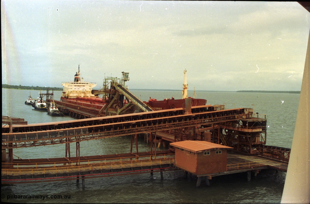 211-30
Weipa, Lorim Point overview looking south east from the kaolin loader at no. 2 berth showing berth construction, tug boats, no. 2 bauxite loader and the TNT Capricornia, a coal fired 75,500-dwt bulk carrier built by Italcantieri for TNT Bulkships trade run between Gladstone and Weipa.
