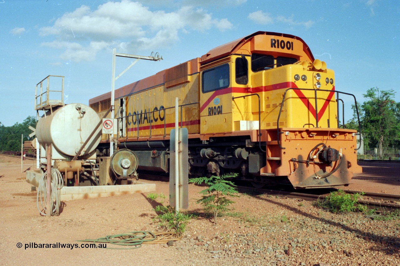 213-04
Weipa, Lorim Point workshops, Comalco R 1001 loco Clyde Engineering built EMD model GT26C serial 72-752 sits at the fuel point, items of note are these units were setup to have the long hood leading, the second 'tropical roof' and the five chime horn cut into the nose. Also noticeable, the units don't have dynamic brakes fitted so there is no brake 'blister' in the middle of the hood like you see on the GT26C models of WAGR L or VR C classes. September 1995.
Keywords: R1001;Clyde-Engineering;EMD;GT26C;72-752;1.001;Comalco;
