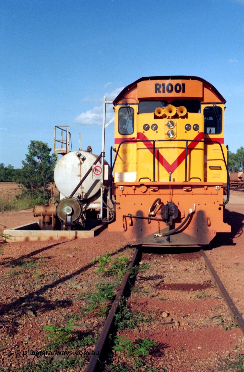 213-12
Weipa, Lorim Point workshops, Comalco R 1001 loco Clyde Engineering built EMD model GT26C serial 72-752 sits at the fuel point, items of note are these units were setup to have the long hood leading, the second 'tropical roof' and the five chime horn cut into the nose. This unit is almost identical to the GT26C models of the WAGR L class. September 1995.
Keywords: R1001;Clyde-Engineering;EMD;GT26C;72-752;1.001;Comalco;