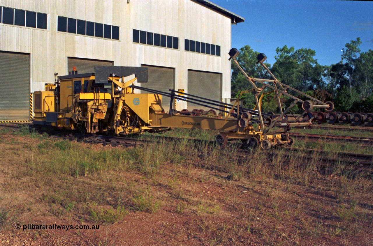 213-15
Weipa, Lorim Point workshops building, looking south east at the rear of the building. Canron Rail Group Mk I switch tamper. Canron was taken over by Harsco in 1990-91.
Keywords: Canron;track-machine;Comalco;