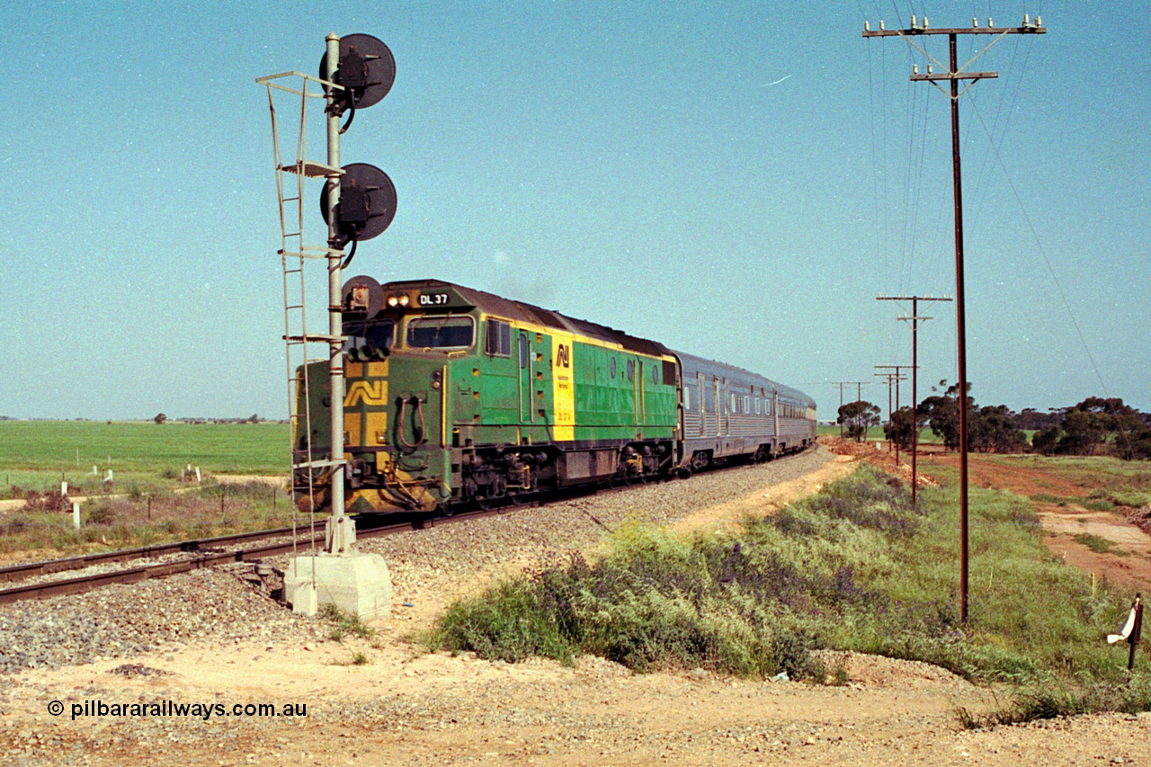 215-03
Long Plains, the down passenger train to Alice Springs 'The Ghan' on approach with power from an AN livered DL class DL 37 Clyde Engineering EMD model AT42C serial 88-1245.
Keywords: DL-class;DL37;Clyde-Engineering-Kelso-NSW;EMD;AT42C;88-1245;