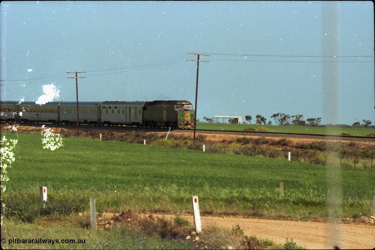 216-02
Long Plains, the down passenger train to Alice Springs 'The Ghan' on approach with power from an AN livered DL class DL 37 Clyde Engineering EMD model AT42C serial 88-1245.
Keywords: DL-class;DL49;Clyde-Engineering-Kelso-NSW;EMD;AT42C;89-1268;