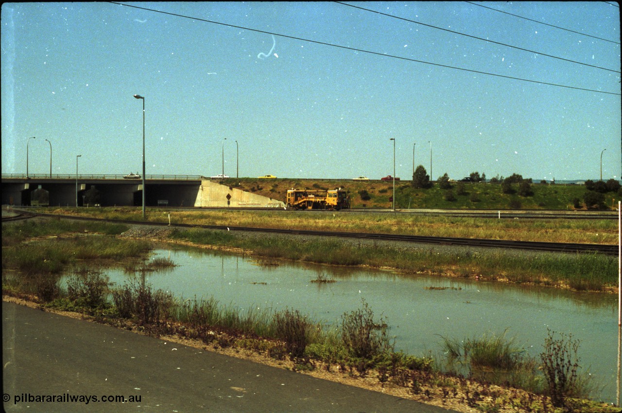 216-20
Dry Creek Motive Power Centre, view looking north as a track tamper arrives into Dry Creek Yard.

