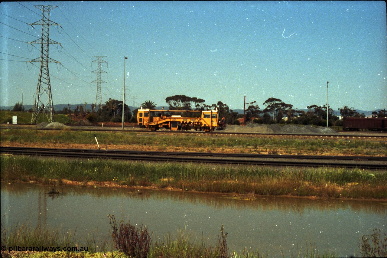 216-21
Dry Creek Motive Power Centre, view looking north as a track tamper arrives into Dry Creek Yard.
