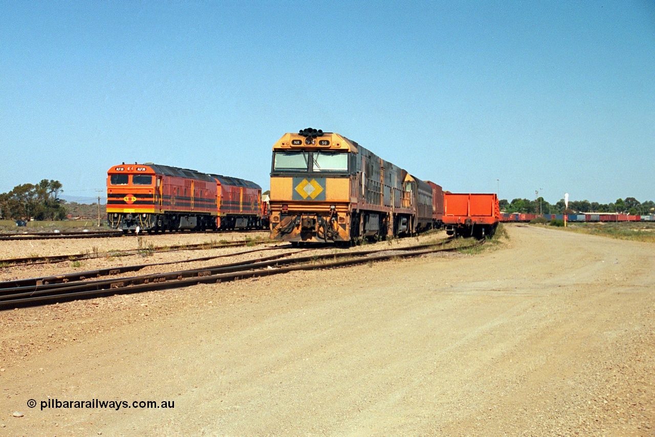 244-02
Port Augusta yard, a pair of ALF class units on the Darwin line construction shunt a rail transport waggon as an SP service wait for departure time with a pair of NR class units. ALF 20 and ALF 18 are both Morrison Knudsen rebuilds, model JT26C-2M serials 94-AN-020 and 94-AN-018.
Keywords: ALF-class;ALF18;ALF20;MKA;EMD;JT26C-2M;94-AN-018;94-AN-020;rebuild;AL-class;NR-class;NR50;Goninan;GE;Cv40-9i;7250-08/97-252;