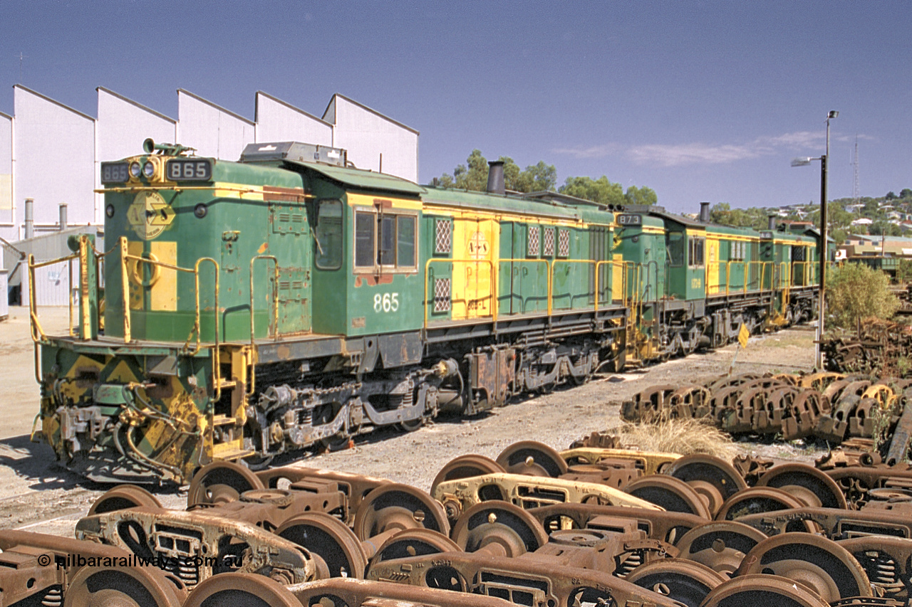 245-05
Port Lincoln loco workshops, still in former owner AN livery, Australian Southern 830 class locomotive 865 AE Goodwin ALCo model DL531 serial 84711, roster shot in multi-unit consist with sister unit 873 and DA class unit DA 6. 6th April 2003.
Keywords: 830-class;865;AE-Goodwin;ALCo;DL531;84711;