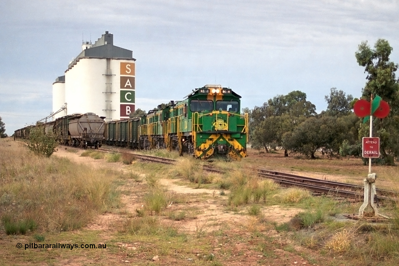 245-16
Wudinna, empty grain train shunts back into the grain siding with a trio of former Australian National Co-Co locomotives with rebuilt former AE Goodwin ALCo model DL531 830 class ex 839, serial no. 83730, rebuilt by Port Augusta Workshops to DA class, DA 4 leading two AE Goodwin ALCo model DL531 830 class units 842, serial no. 84140 and 851 serial no. 84137, 851 having been on the Eyre Peninsula since delivered in 1962. 7th April, 2003.
Keywords: DA-class;DA4;83730;Port-Augusta-WS;ALCo;DL531G/1;830-class;839;rebuild;