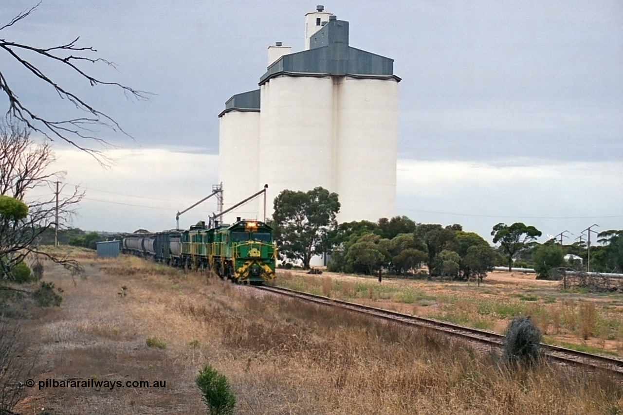 245-25
Yaninee, empty grain train behind a trio of former Australian National Co-Co locomotives with rebuilt former AE Goodwin ALCo model DL531 830 class ex 839, serial no. 83730, rebuilt by Port Augusta Workshops to DA class, leading two AE Goodwin ALCo model DL531 830 class units 842, serial no. 84140 and 851 serial no. 84137, 851 having been on the Eyre Peninsula since delivered in 1962, runs through express on the mainline. 7th April, 2003.
Keywords: DA-class;DA4;83730;Port-Augusta-WS;ALCo;DL531G/1;830-class;839;rebuild;