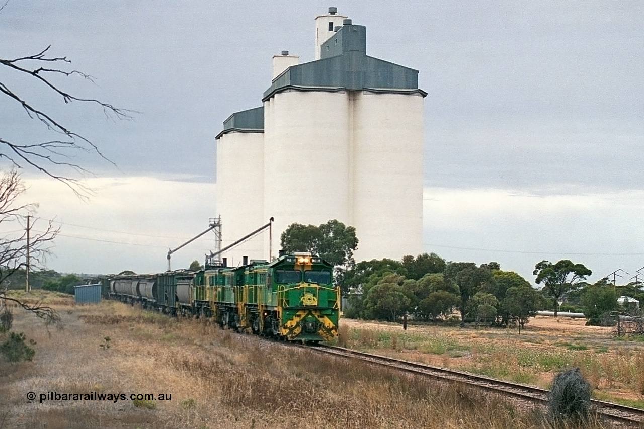 245-26
Yaninee, empty grain train behind a trio of former Australian National Co-Co locomotives with rebuilt former AE Goodwin ALCo model DL531 830 class ex 839, serial no. 83730, rebuilt by Port Augusta Workshops to DA class, leading two AE Goodwin ALCo model DL531 830 class units 842, serial no. 84140 and 851 serial no. 84137, 851 having been on the Eyre Peninsula since delivered in 1962, runs through express on the mainline. 7th April, 2003.
Keywords: DA-class;DA4;83730;Port-Augusta-WS;ALCo;DL531G/1;830-class;839;rebuild;