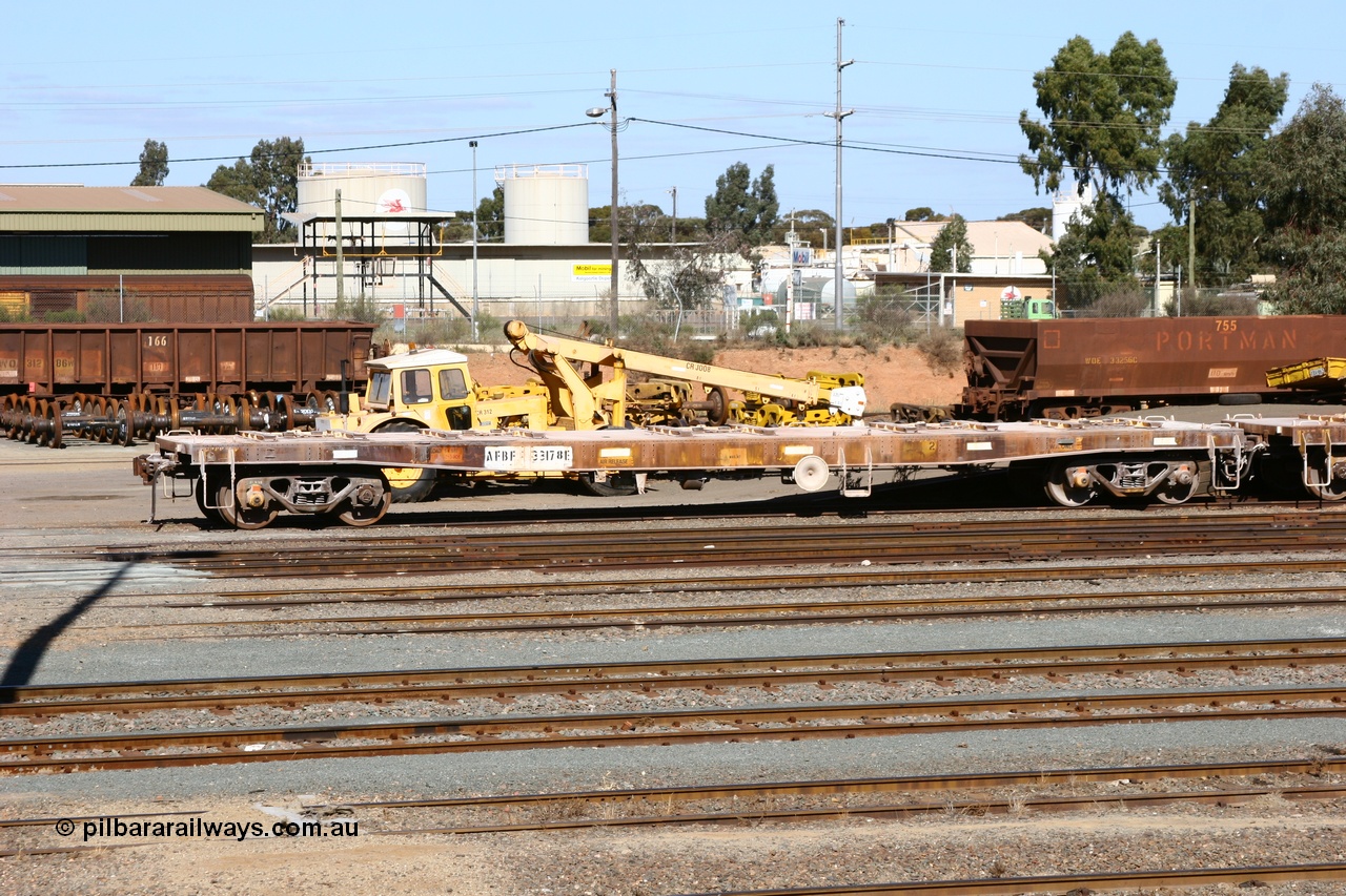 060528 4439
West Kalgoorlie, looking across to the waggon repair facility, in the foreground is flat waggon AFBF 33178 modified for kibble service originally built by WAGR Midland Workshops in 1970 as a WGX type open waggon, but behind is red carded WO type waggon WO 31286 with fleet number 166 and WOE type WOE 33256 with fleet number 755. 28th May 2006.
Keywords: AFBF-type;AFBF33178;WAGR-Midland-WS;WGX-type;WGG-type;WOSF-type;