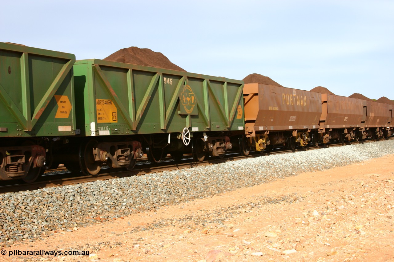 060531 5009
Binduli, AOPY 34079, fleet number 945, one of seventy ex ANR coal waggons rebuilt from AOKF type by Bluebird Engineering SA in service with ARG on Koolyanobbing iron ore trains. They used to be three metres longer and originally built by Metropolitan Cammell Britain as GB type in 1952-55, seen here in the consist with sister waggons and WOE type waggons, on a loaded train bound for West Kalgoorlie, 31st May 2006.
Keywords: AOPY-type;AOPY34079;Bluebird-Engineering-SA;Metropolitan-Cammell-Britain;GB-type;