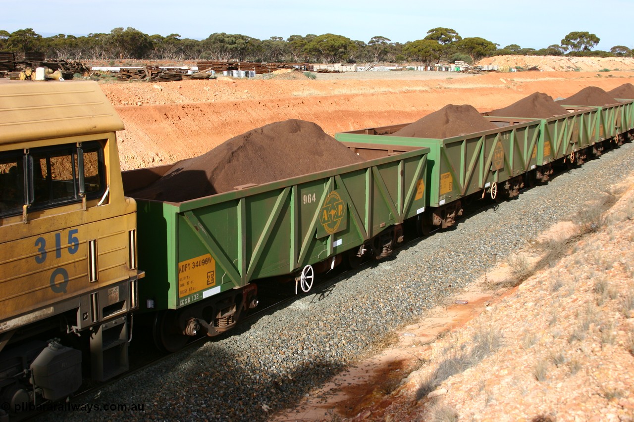 060531 5020
West Kalgoorlie, AOPY 34096 with fleet number 964 and of the drop floor type, one of seventy ex ANR coal waggons rebuilt from AOKF type by Bluebird Engineering SA in service with ARG on Koolyanobbing iron ore trains. They used to be three metres longer and originally built by Metropolitan Cammell Britain as GB type in 1952-55, 31st May 2006.
Keywords: AOPY-type;AOPY34096;Bluebird-Engineering-SA;Metropolitan-Cammell-Britain;GB-type;