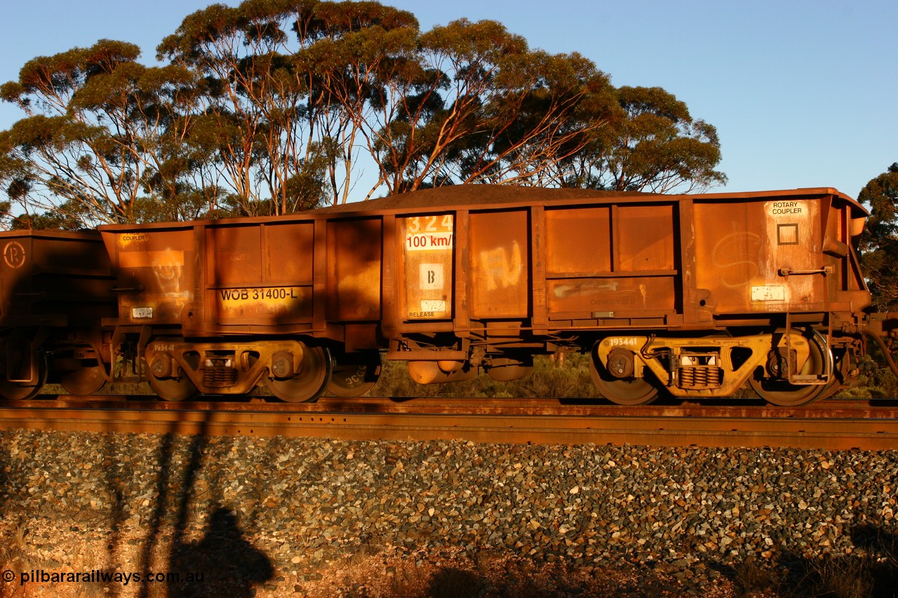 070530 9591
WOB type iron ore waggon WOB 31400 is one of a batch of twenty five built by Comeng WA between 1974 and 1975 and converted from Mt Newman high sided waggons by WAGR Midland Workshops with a capacity of 67 tons with fleet number 324 for Koolyanobbing iron ore operations, but purchased by WAGR. This waggon is one of the 15 converted to WSM type ballast hoppers by re-fitting the removed top section of the body and fitting bottom discharge doors, converted back to WOB in 1998. The angled lines from this conversion are still visible. Loaded train at Binduli, 30th May 2007.
Keywords: WOB-type;WOB31400;Comeng-WA;WSM-type;Mt-Newman-Mining;