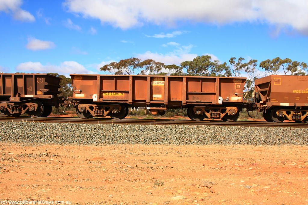 100729 01488
WOB type iron ore waggon WOB 31391 is one of a batch of twenty five built by Comeng WA between 1974 and 1975 and converted from Mt Newman high sided waggons by WAGR Midland Workshops with a capacity of 67 tons with fleet number 316 for Koolyanobbing iron ore operations. This waggon was also converted to a WSM type ballast hopper by re-fitting the cut down top section and having bottom discharge doors fitted, converted back to WOB in 1998, returning empty to Koolyanobbing at Binduli, 29th July 2010.
Keywords: WOB-type;WOB31391;Comeng-WA;WSM-type;Mt-Newman-Mining;