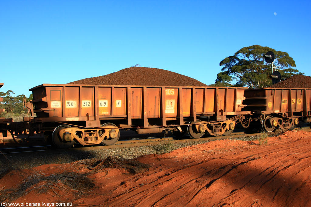 100731 02350
WO type iron ore waggon WO 31209 is leader of a batch of sixty two built by Goninan WA between April and August 2000 with serial number 950086-001 and fleet number 105 for Koolyanobbing iron ore operations, and is a Goninan built replacement WO type waggon with a build date of 05/2000, this replaces the original WAGR built WO type waggon with a WOD type with square features opposed to the curved ones as on the original WO, on loaded train 6413 at Binduli Triangle, 31st July 2010.
Keywords: WO-type;WO31209;Goninan-WA;950086-001;