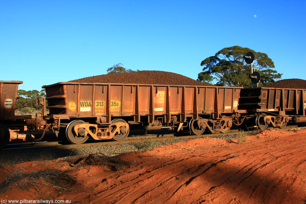 100731 02360
WOA type iron ore waggon WOA 31335 is one of a batch of thirty nine built by WAGR Midland Workshops between 1970 and 1971 with fleet number 215 for Koolyanobbing iron ore operations, with a 75 ton and 1018 ft³ capacity, on loaded train 6413 at Binduli Triangle, 31st July 2010.
Keywords: WOA-type;WOA31335;WAGR-Midland-WS;