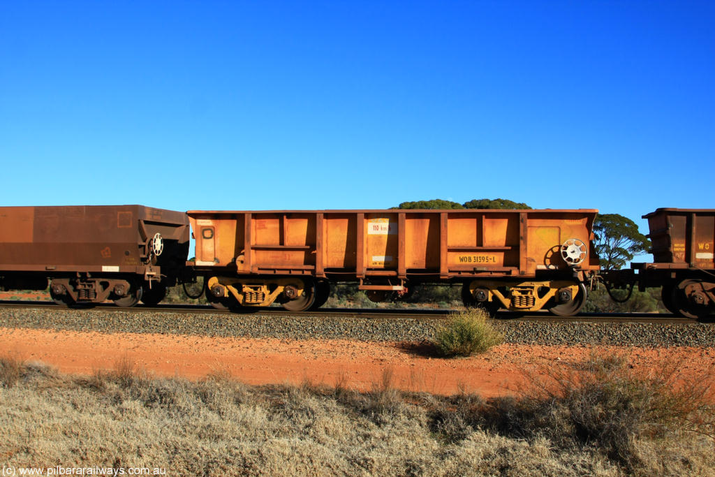 100731 02426
WOB type iron ore waggon WOB 31395 is one of a batch of twenty five built by Comeng WA between 1974 and 1975 and converted from Mt Newman high sided waggons by WAGR Midland Workshops with a capacity of 67 tons with fleet number 325 for Koolyanobbing iron ore operations. This waggon was also converted to a WSM type ballast hopper by re-fitting the cut down top section and having bottom discharge doors fitted, converted back to WOB in 1997, on empty train 6418 at Binduli Triangle, 31st July 2010.
Keywords: WOB-type;WOB31395;Comeng-WA;WSM-type;Mt-Newman-Mining;