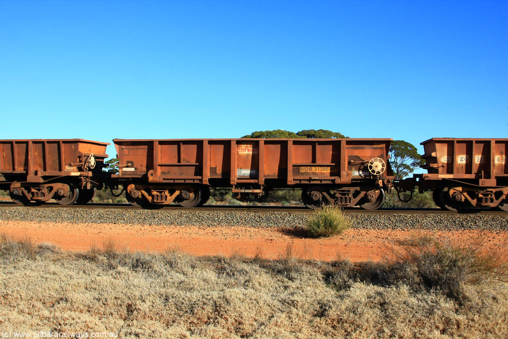 100731 02439
WOB type iron ore waggon WOB 31386 is one of a batch of twenty five built by Comeng WA between 1974 and 1975 and converted from Mt Newman high sided waggons by WAGR Midland Workshops with a capacity of 67 tons with fleet number 311 for Koolyanobbing iron ore operations. This waggon was also converted to a WSM type ballast hopper by re-fitting the cut down top section and having bottom discharge doors fitted, converted back to WOB in 1998, on empty train 6418 at Binduli Triangle, 31st July 2010.
Keywords: WOB-type;WOB31386;Comeng-WA;WSM-type;Mt-Newman-Mining;