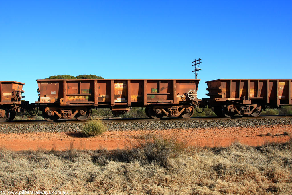 100731 02537
WOB type iron ore waggon WOB 31388 is one of a batch of twenty five built by Comeng WA between 1974 and 1975 and converted from Mt Newman high sided waggons by WAGR Midland Workshops with a capacity of 67 tons with fleet number 313 for Koolyanobbing iron ore operations. This waggon was also converted to a WSM type ballast hopper by re-fitting the cut down top section and having bottom discharge doors fitted, converted back to WOB in 1998, on empty train 6418 at Binduli Triangle, 31st July 2010.
Keywords: WOB-type;WOB31388;Comeng-WA;WSM-type;Mt-Newman-Mining;