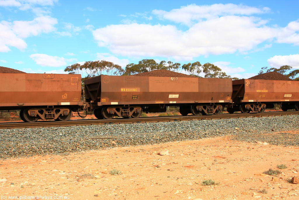 100731 02836
WOE type iron ore waggon WOE 31114 is one of a batch of one hundred and thirty built by Goninan WA between March and August 2001 with serial number 950092-104 and fleet number 697 for Koolyanobbing iron ore operations, on loaded train 7415 at Binduli Triangle, 31st July 2010.
Keywords: WOE-type;WOE31114;Goninan-WA;950092-104;