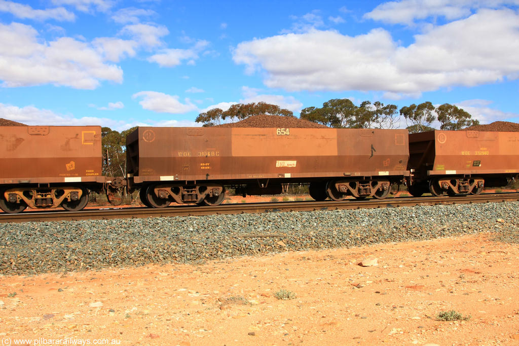 100731 02867
WOE type iron ore waggon WOE 31068 is one of a batch of one hundred and thirty built by Goninan WA between March and August 2001 with serial number 950092-058 and fleet number 654 for Koolyanobbing iron ore operations, on loaded train 7415 at Binduli Triangle, 31st July 2010.
Keywords: WOE-type;WOE31068;Goninan-WA;950092-058;