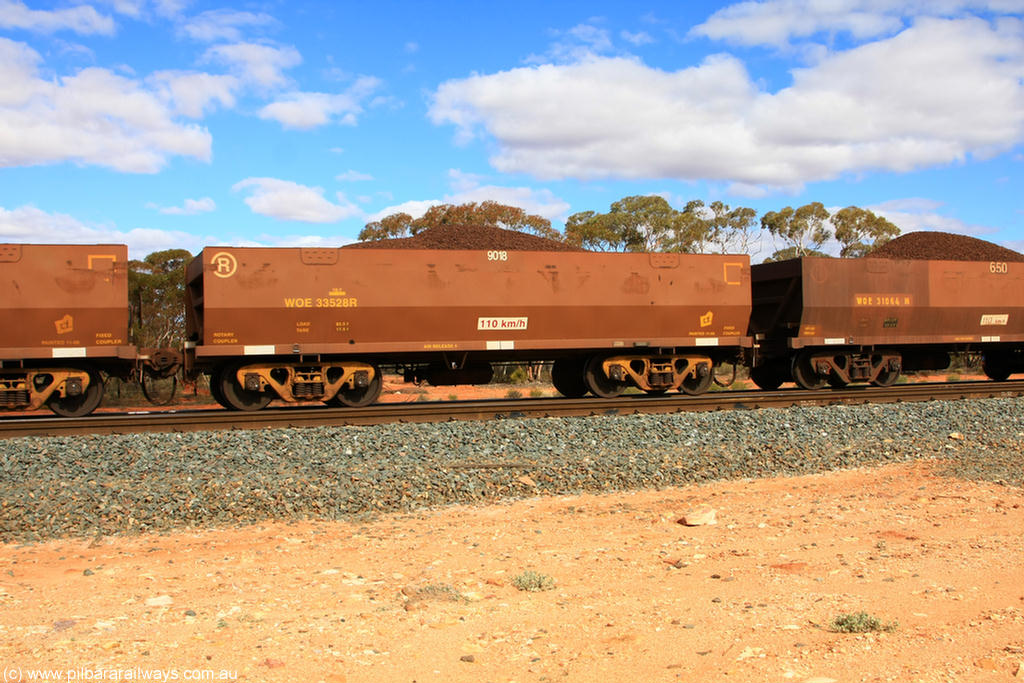 100731 02872
WOE type iron ore waggon WOE 33528 is one of a batch of one hundred and twenty eight built by United Group Rail WA between August 2008 and March 2009 with serial number 950211-068 and fleet number 9018 for Koolyanobbing iron ore operations, on loaded train 7415 at Binduli Triangle, 31st July 2010.
Keywords: WOE-type;WOE33528;United-Group-Rail-WA;950211-068;