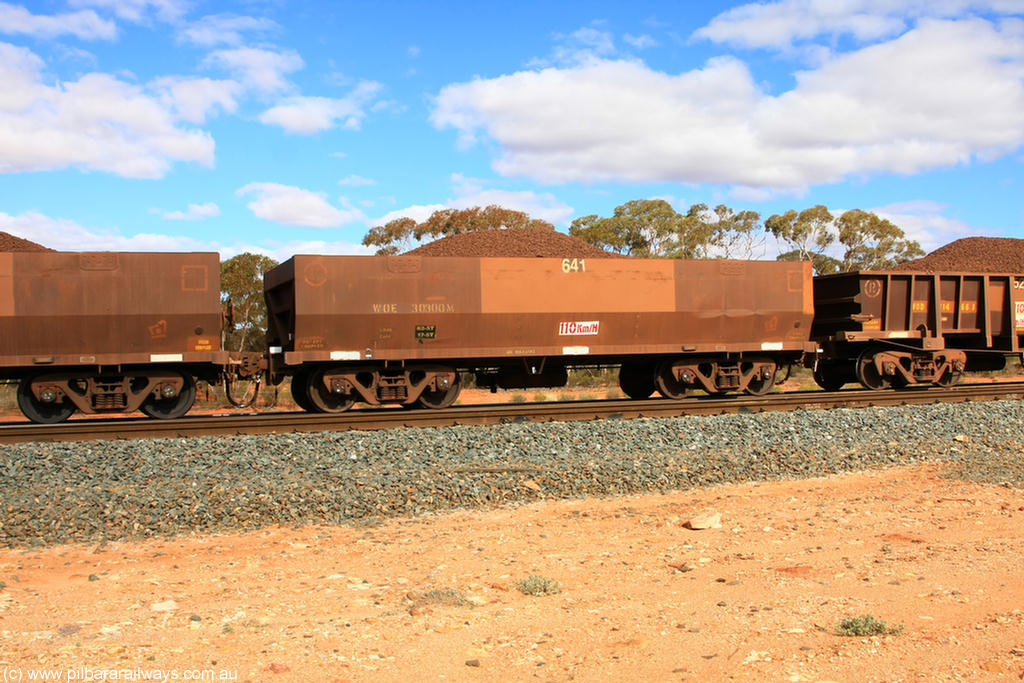 100731 02874
WOE type iron ore waggon WOE 30300 is one of a batch of one hundred and thirty built by Goninan WA between March and August 2001 with serial number 950092-050 and fleet number 641 for Koolyanobbing iron ore operations, on loaded train 7415 at Binduli Triangle, 31st July 2010.
Keywords: WOE-type;WOE30300;Goninan-WA;950092-050;