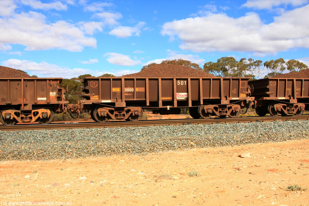 100731 02877
WOD type iron ore waggon WOD 31300 is one of a batch of sixty two built by Goninan WA between April and August 2000 with serial number 950086-011 and fleet number 501 for Koolyanobbing iron ore operations with a 75 ton capacity and a replacement for a WO type waggon number, for Portman Mining to cart their Koolyanobbing iron ore to Esperance, on loaded train 7415 at Binduli Triangle, 31st July 2010.
Keywords: WOD-type;WOD31300;Goninan-WA;950086-011;