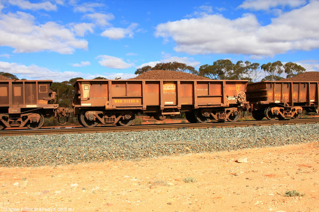 100731 02880
WOB type iron ore waggon WOB 31393 is one of a batch of twenty five built by Comeng WA between 1974 and 1975 and converted from Mt Newman high sided waggons by WAGR Midland Workshops with a capacity of 67 tons with fleet number 318 for Koolyanobbing iron ore operations. This waggon was also converted to a WSM type ballast hopper by re-fitting the cut down top section and having bottom discharge doors fitted, converted back to WOB in 1998, on loaded train 7415 at Binduli Triangle, 31st July 2010.
Keywords: WOB-type;WOB31393;Comeng-WA;WSM-type;Mt-Newman-Mining;