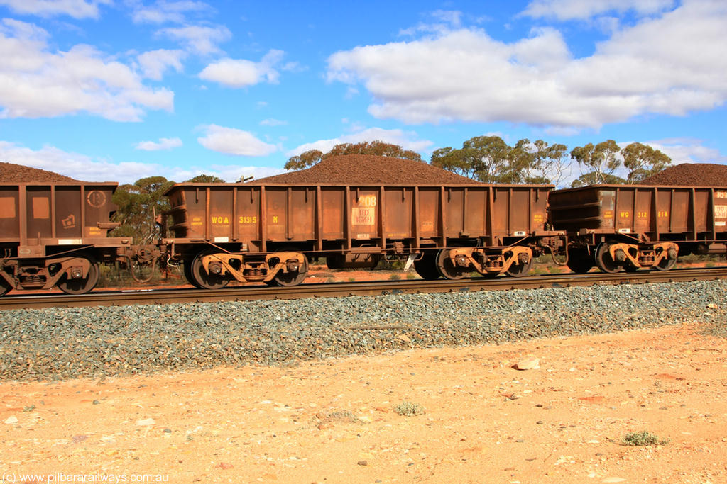 100731 02890
WOA type iron ore waggon WOA 31315 is one of a batch of thirty nine built by WAGR Midland Workshops between 1970 and 1971 with fleet number 208 for Koolyanobbing iron ore operations, with a 75 ton and 1018 ft³ capacity, on loaded train 7415 at Binduli Triangle, 31st July 2010.
Keywords: WOA-type;WOA31315;WAGR-Midland-WS;