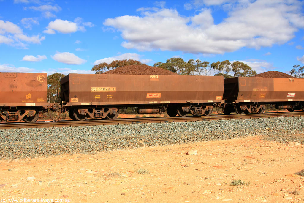 100731 02915
WOE type iron ore waggon WOE 31073 is one of a batch of one hundred and thirty built by Goninan WA between March and August 2001 with serial number 950092-063 and fleet number 659 for Koolyanobbing iron ore operations, on loaded train 7415 at Binduli Triangle, 31st July 2010.
Keywords: WOE-type;WOE31073;Goninan-WA;950092-063;